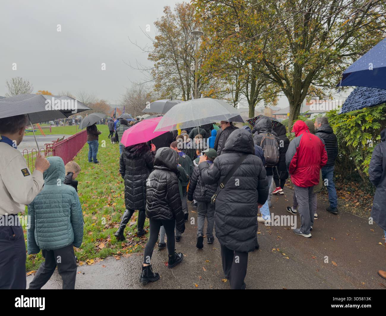 Ormskirk Remembrance Parade, Ormskirk Lancashire UK UK. Despite the pouring rain many people turned out mark the occasion and pay their respects. Nove - Smartphone Captured Stock Image