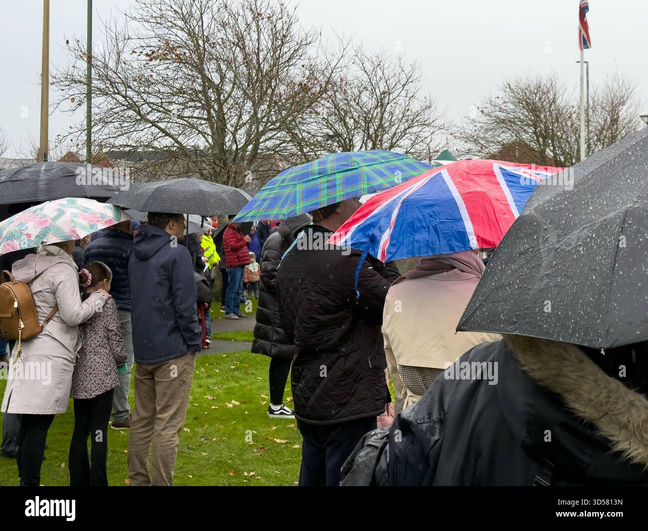 Ormskirk Remembrance Parade, Ormskirk Lancashire UK UK. Despite the pouring rain many people turned out mark the occasion and pay their respects. Nove - Smartphone Captured Stock Image