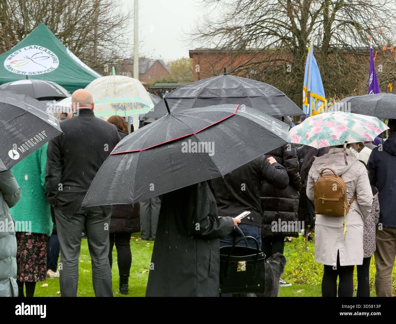 Ormskirk Remembrance Parade, Ormskirk Lancashire UK UK. Despite the pouring rain many people turned out mark the occasion and pay their respects. Nove - Smartphone Captured Stock Image