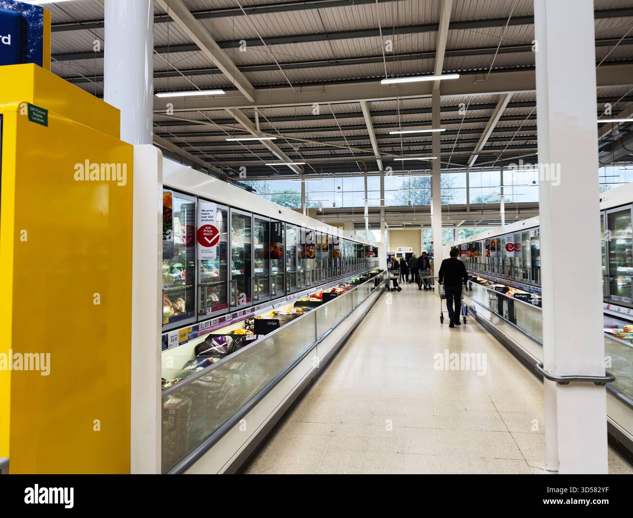 Manchester, UK - September 30, 2025: Shoppers push carts along a long ...