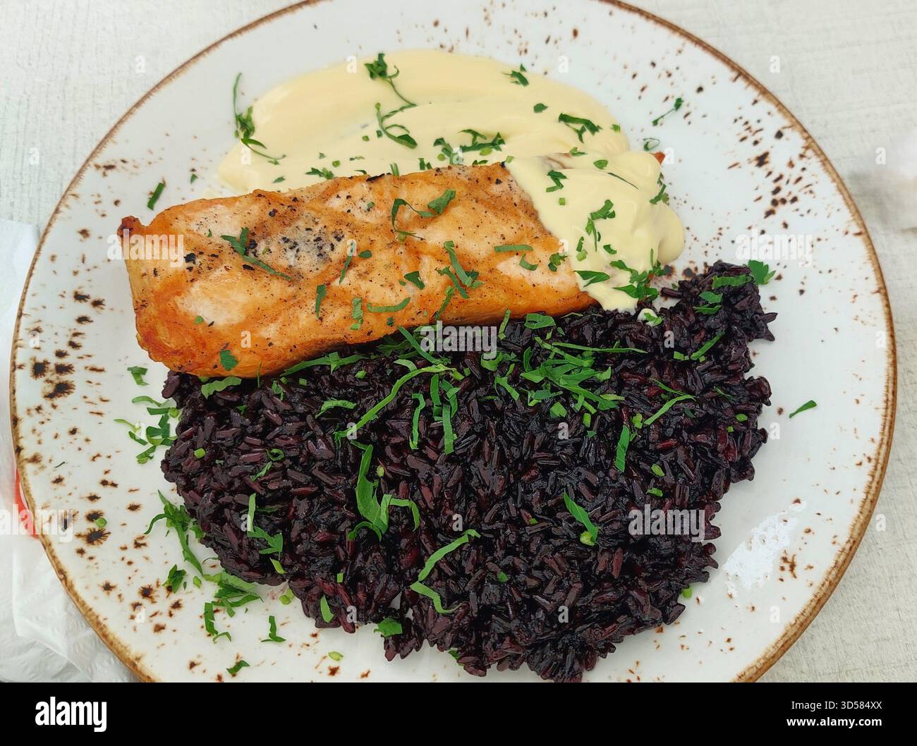Bulgarian Cod Fish with Black Rice and Bearnaise Sauce Stock Photo - Alamy