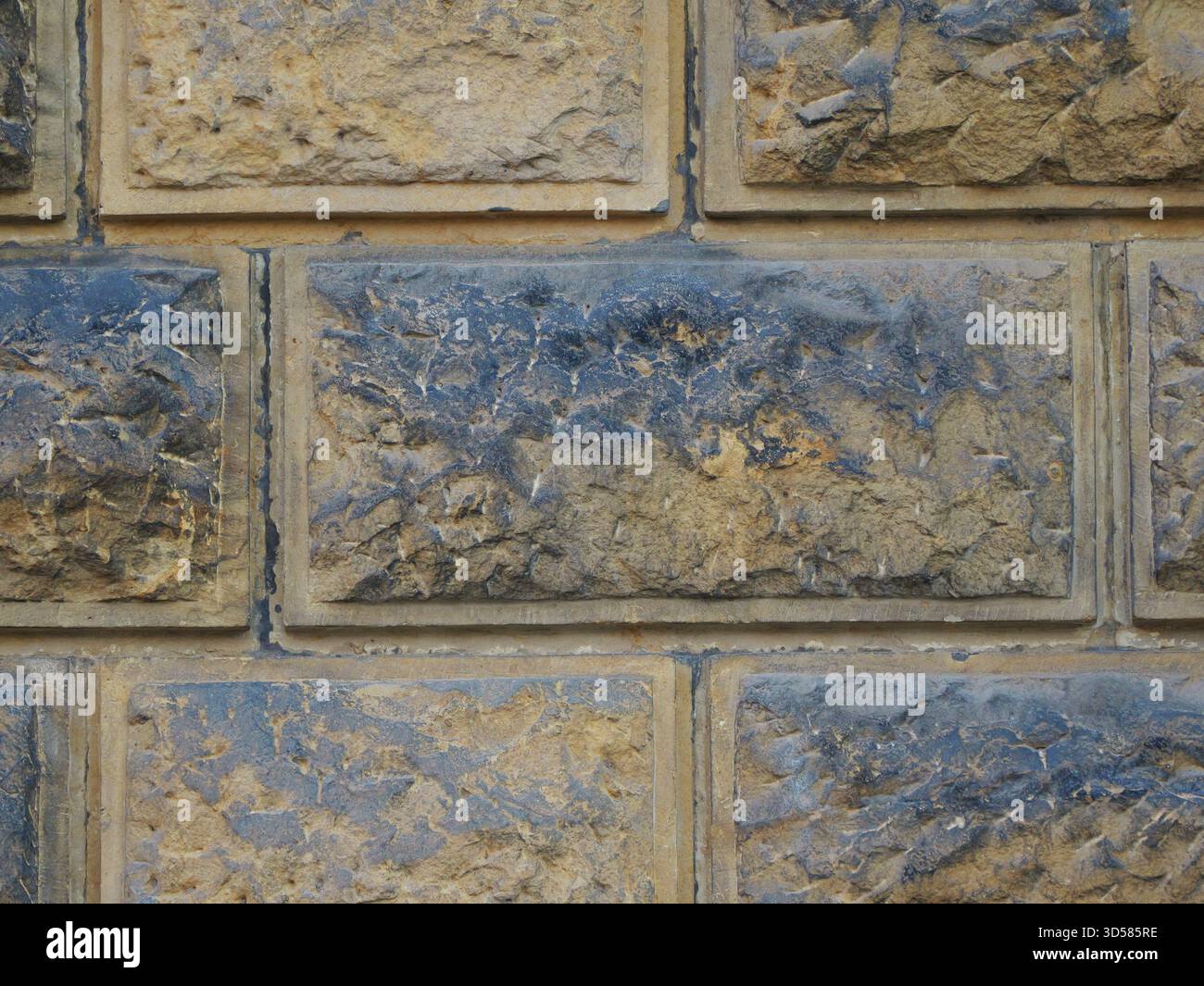Historic rusticated stone wall with irregular, rough blocks. Close-up. Copyspace. Stock Photo