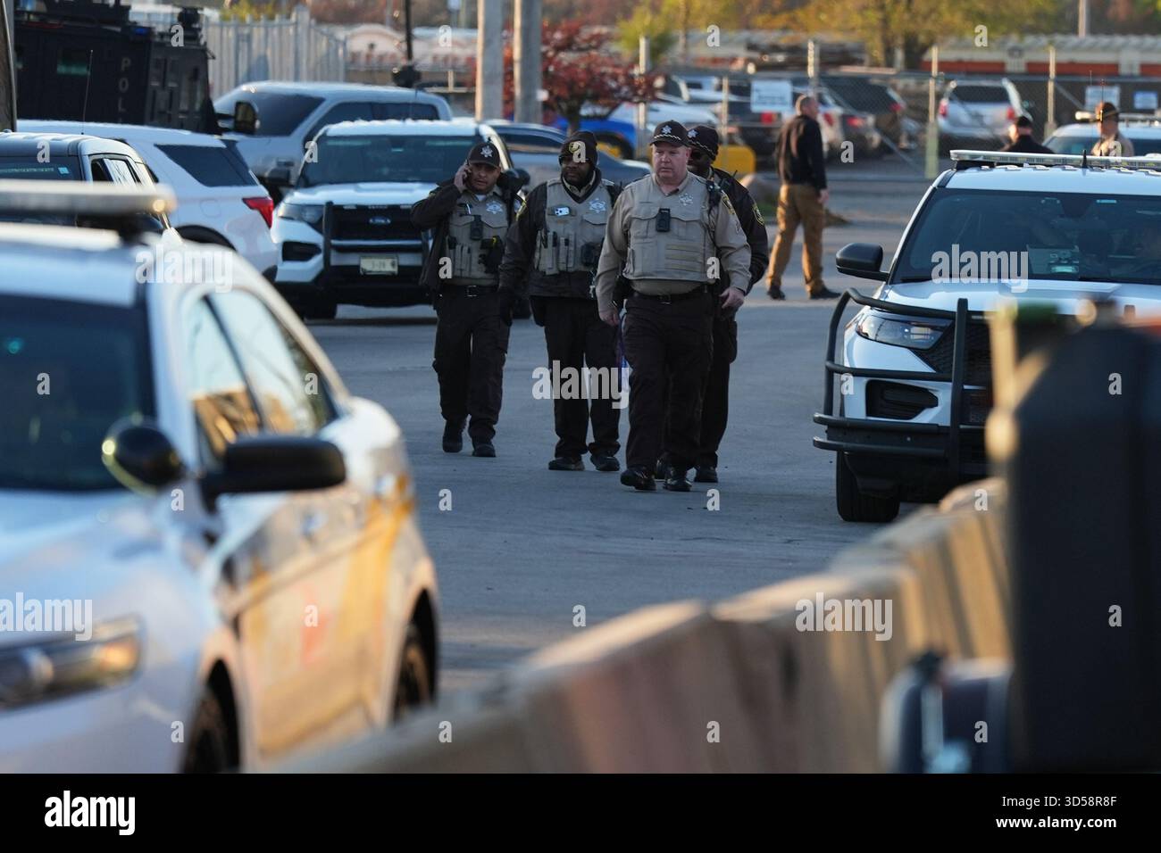 Police are seen as protesters gather outside an ICE processing facility ...