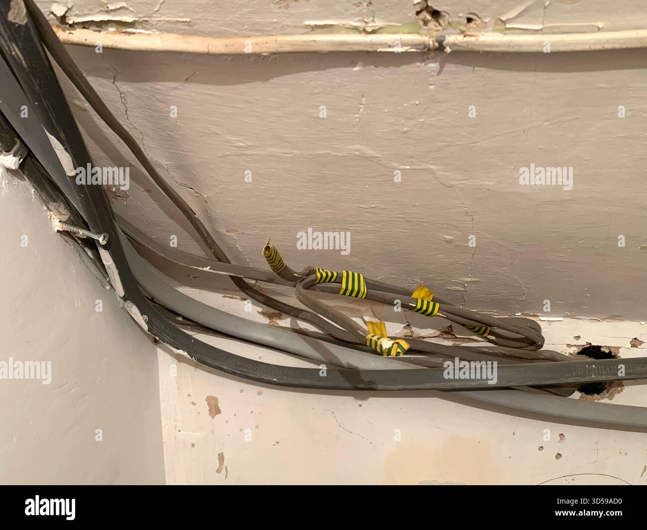 Electric box consumer unit danger electric shock electrical switch switches damaged front trip trips isolator taped live wires wired sign signs kill - Smartphone Captured Stock Image