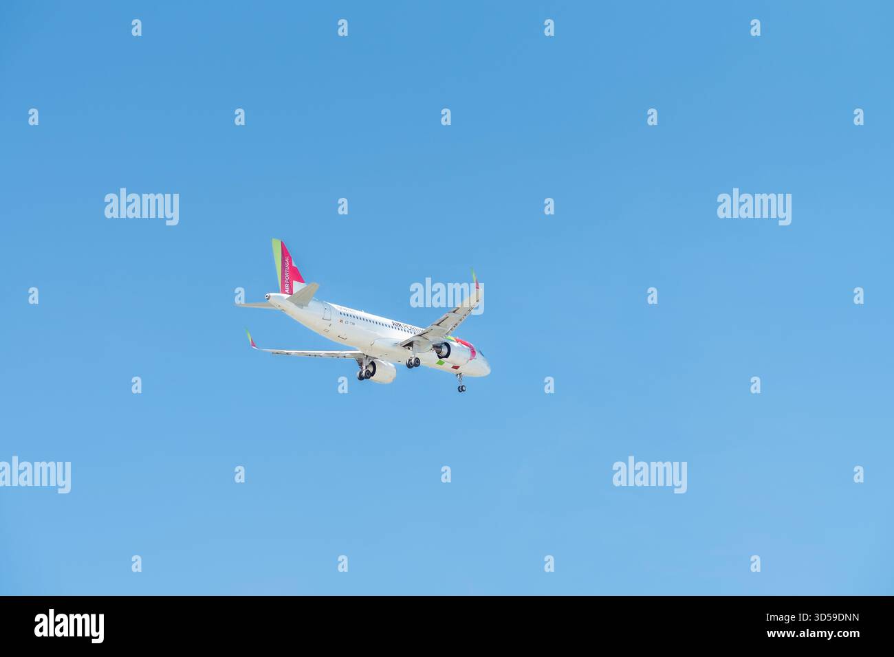 Portugal, Algarve region - September 12, 2025: A TAP Air Portugal passenger airplane approaches Faro Airport, flying low over traditional Mediterranea Stock Photo