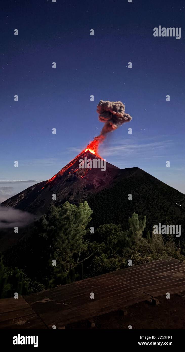 Spetacular night eruption of Fuego Volcano with lava jets and ash plume, Guatemala - Smartphone Captured Stock Image