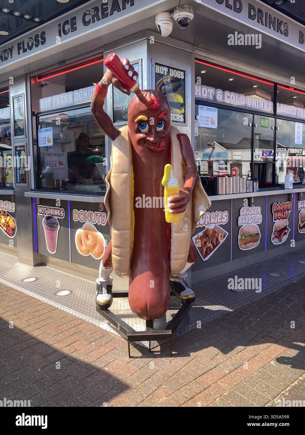 A hotdog figure statue outside a cafe in Hemsby near Great Yarmouth in Norfolk - Smartphone Captured Stock Image