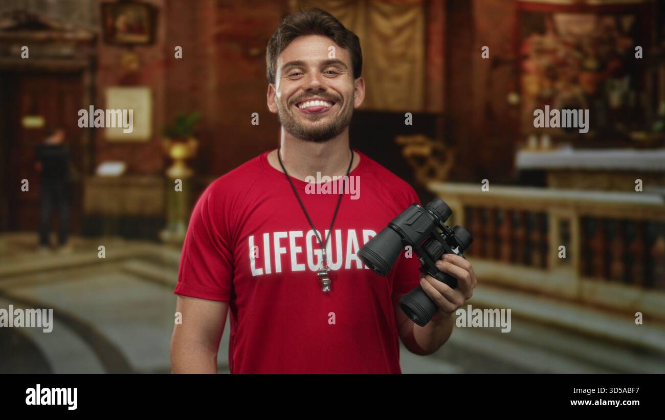 Man lifeguard in red shirt holding binoculars and a whistle, smiling ...