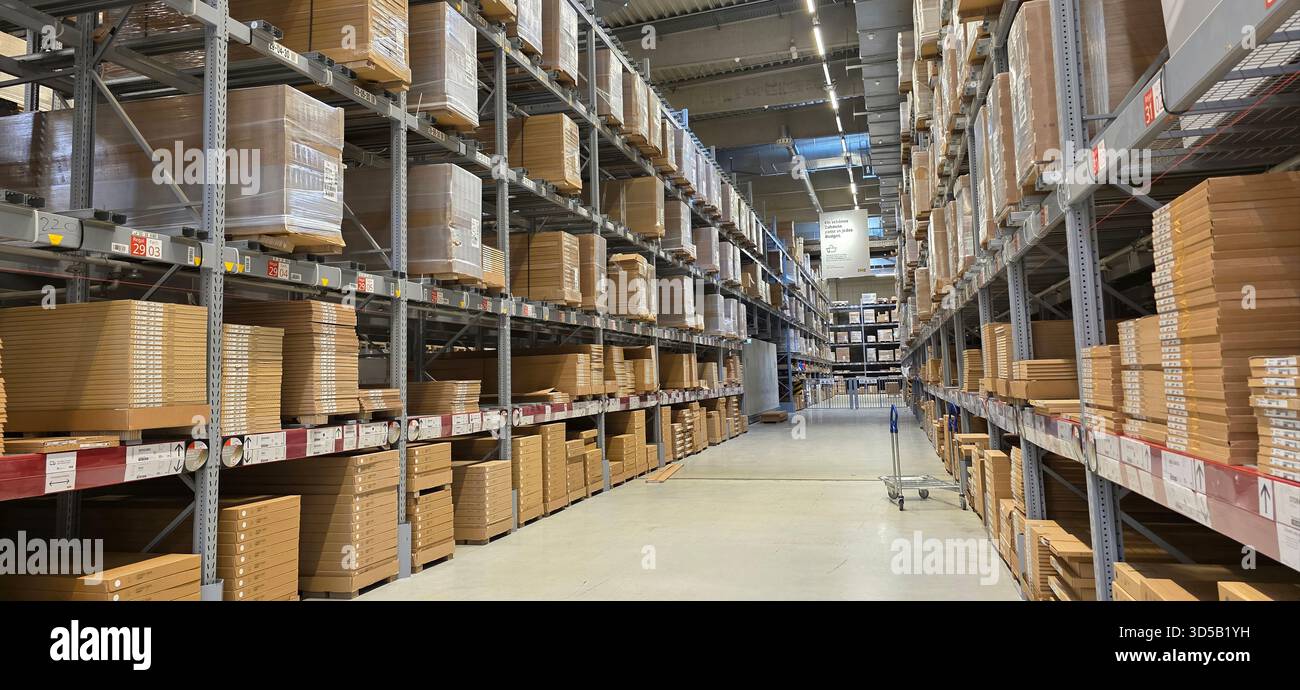 Berlin, Germany - May 05, 2025: Warehouse interior features organized shelves filled with cardboard boxes for efficient storage. - Smartphone Captured Stock Image