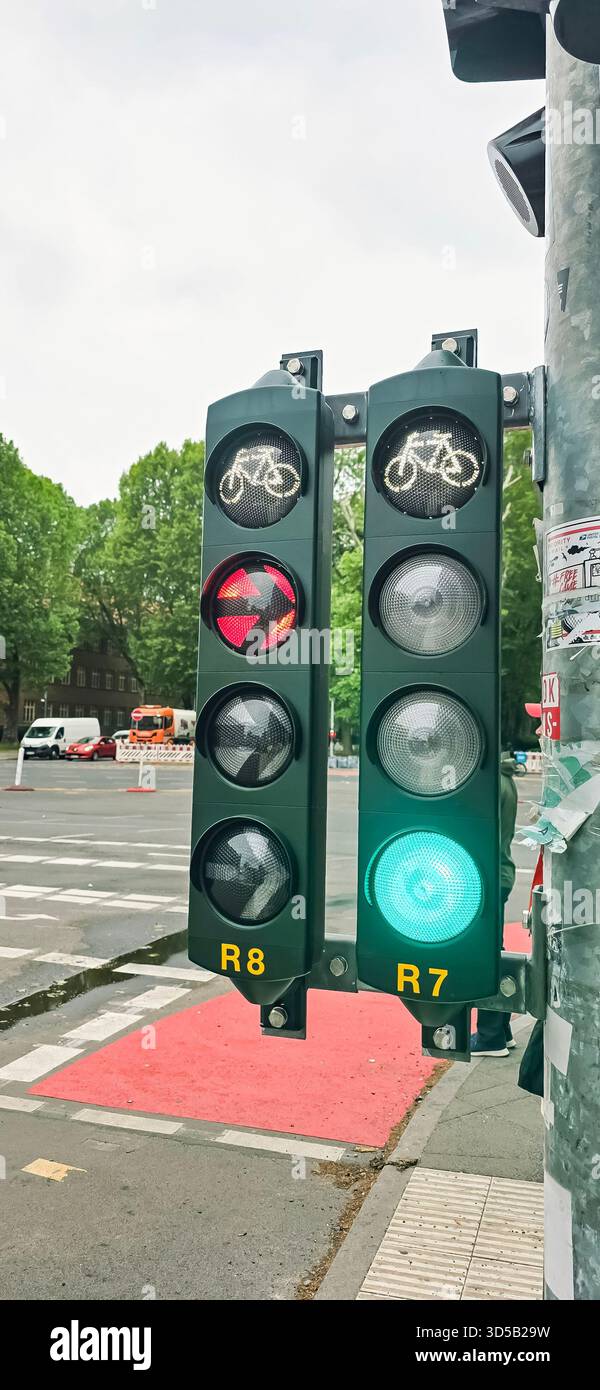 Belin, Germany - May 19, 2025: Traffic light displays bicycle signals and green light for cyclists in busy urban intersection. - Smartphone Captured Stock Image