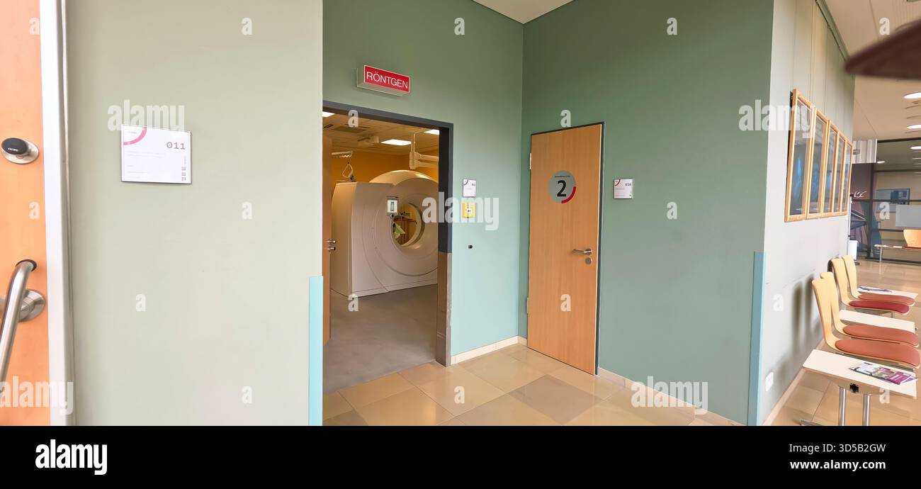 Berlin, Germany - June 16, 2025: Hospital corridor features MRI room entrance and waiting area with chairs. - Smartphone Captured Stock Image