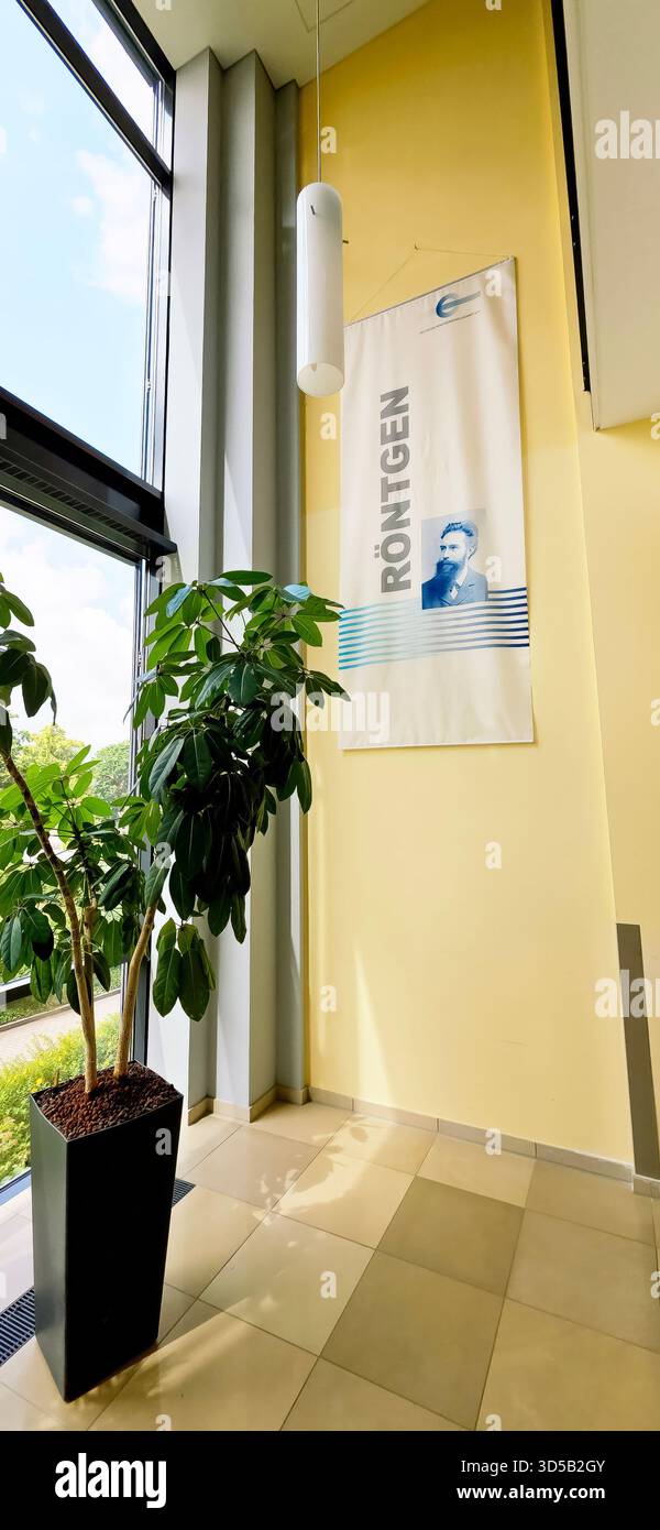 Berlin, Germany - June 16, 2025: Rontgen banner is showcased in a contemporary space with an indoor plant beside it. - Smartphone Captured Stock Image