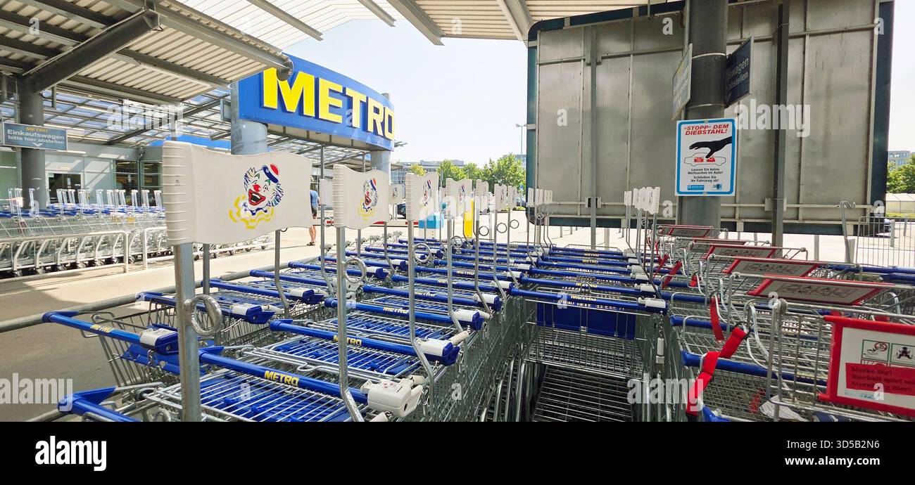 Berlin, Germany - June 21, 2025: METRO supermarket features shopping carts neatly arranged outside the store. - Smartphone Captured Stock Image