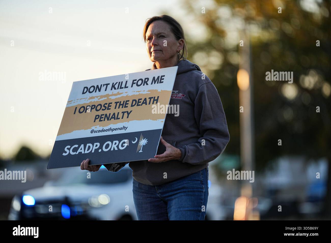 A protester holds a sign outside of Broad River Correctional Institute ...