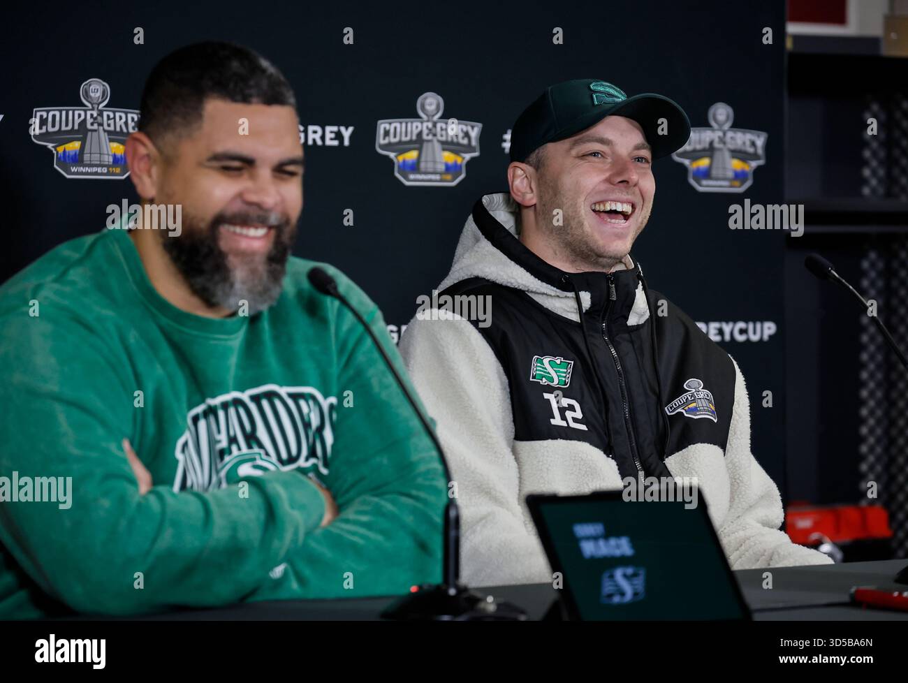 Corey Brett Riddle Saskatchewan Roughriders' Brett Lauther, right, jokes with head coach ...