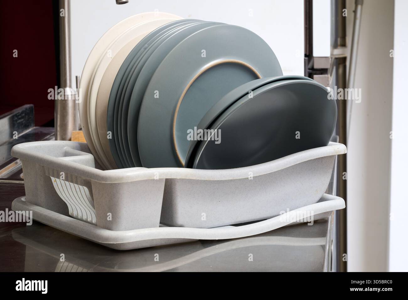 the dishes dry on the drying rack from front Stock Photo