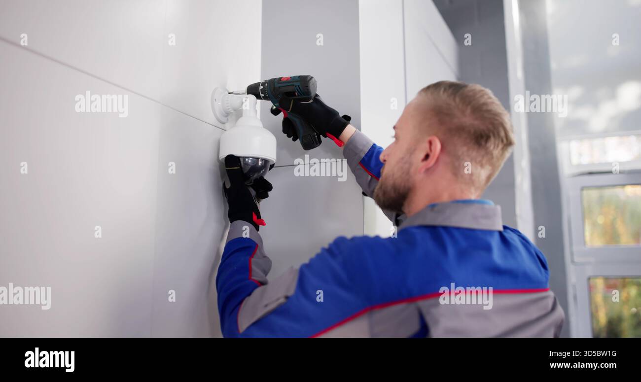 Professional Technician Installing CCTV Camera For Security Surveillance Video Service. Stock Photo