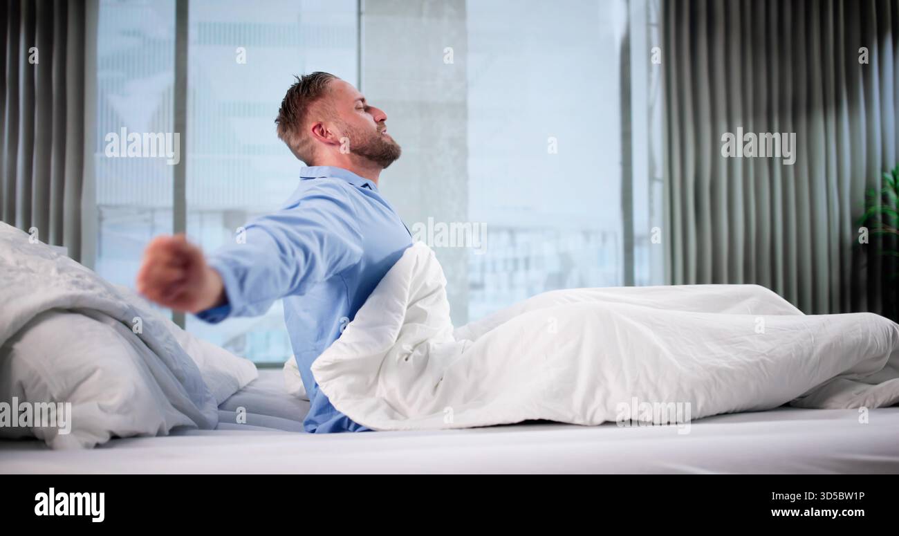 Happy Man Waking Up, Stretching Whole Body, Ready For Day. Stock Photo