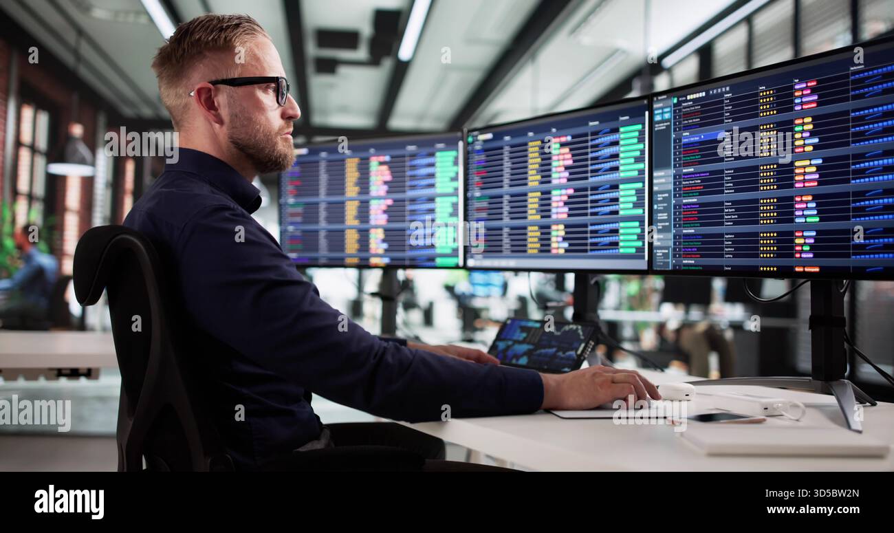 Young Male Billing Analyst Working On Medical Coding Spreadsheets Online. Stock Photo