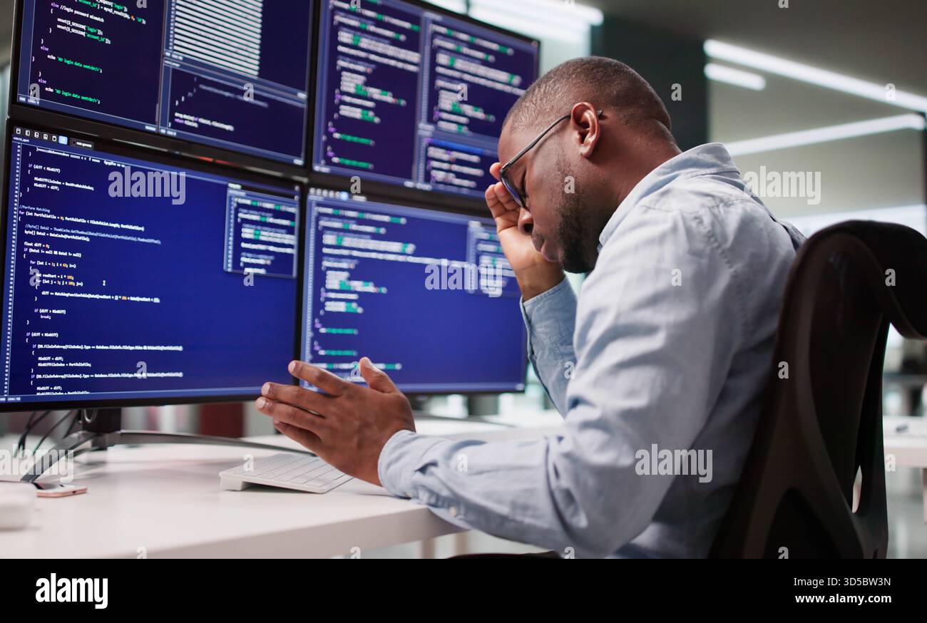 Sad Programmer Frustrated By Coding At Business Desk With Broken System. Stock Photo