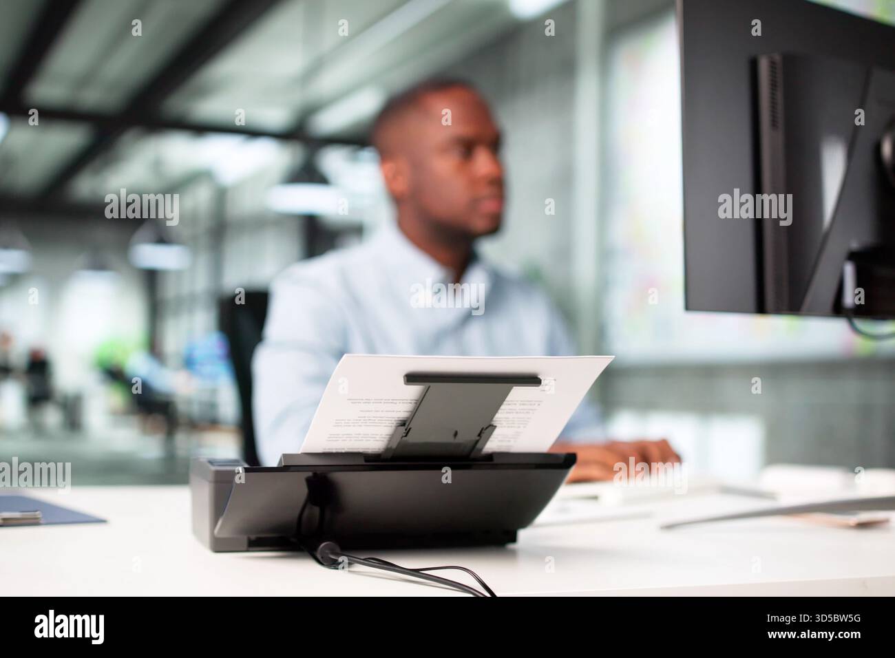 Man Digitizing Paper Documents Using Scanner In Office Profession: Accountant Stock Photo