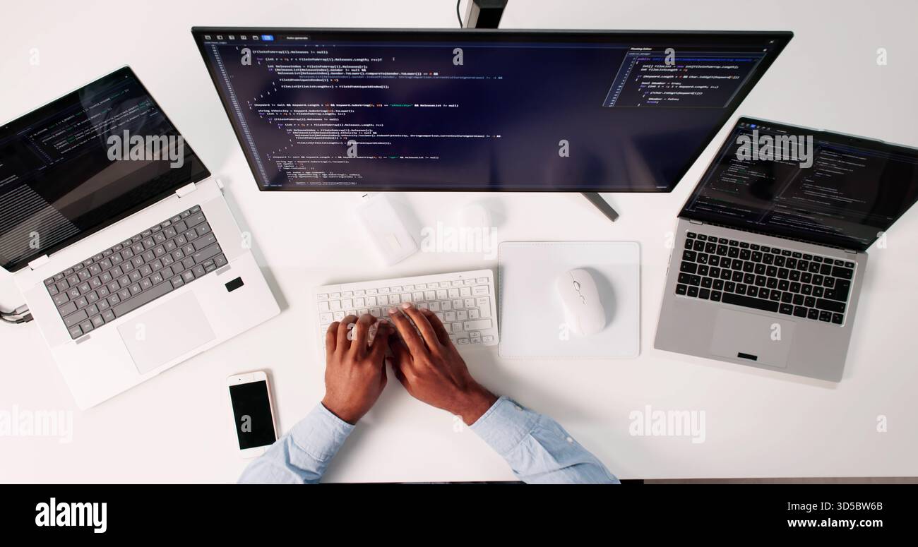 Top View Of African American Programmer Man Coding On Computer Stock Photo