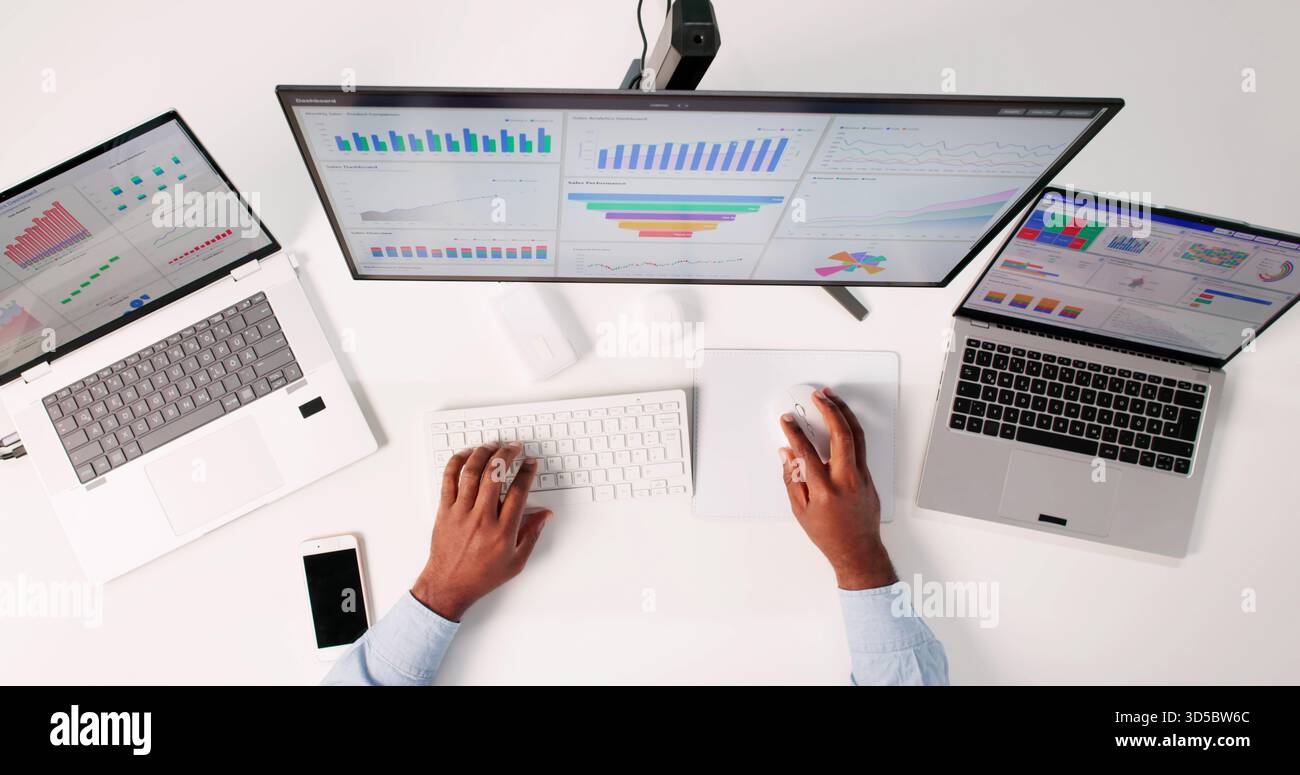 Man Analyzing Business Data On Top Screen In High Office. Stock Photo
