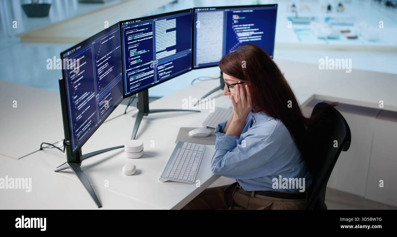 Unhappy Woman Frustrated With Vibe While Coding On Her Computer. Stock Photo