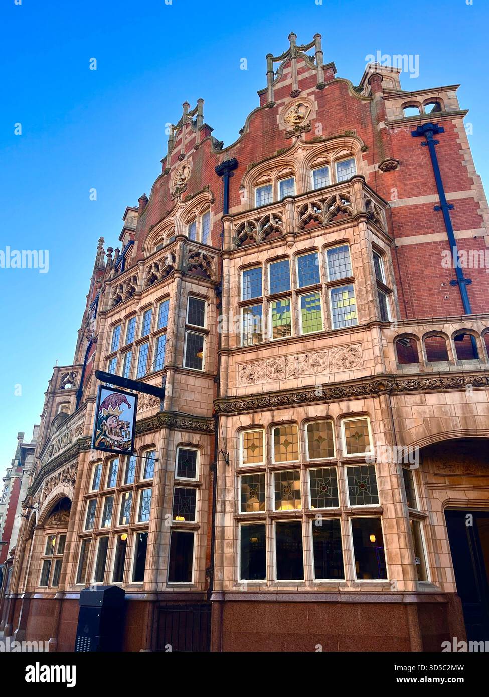 Detailed view of an ornate historic red brick building with decorative stonework and large windows in Hull city centre, England. - Smartphone Captured Stock Image
