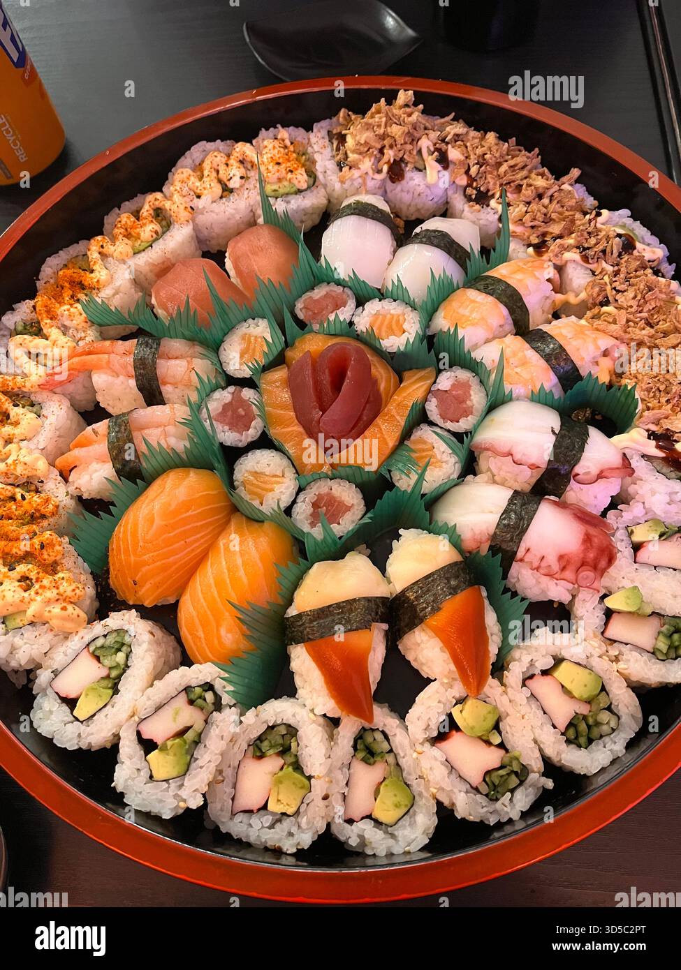 High-resolution close-up of a colourful assorted sushi platter with nigiri and maki rolls, beautifully arranged on a round tray in Hull, England. - Smartphone Captured Stock Image