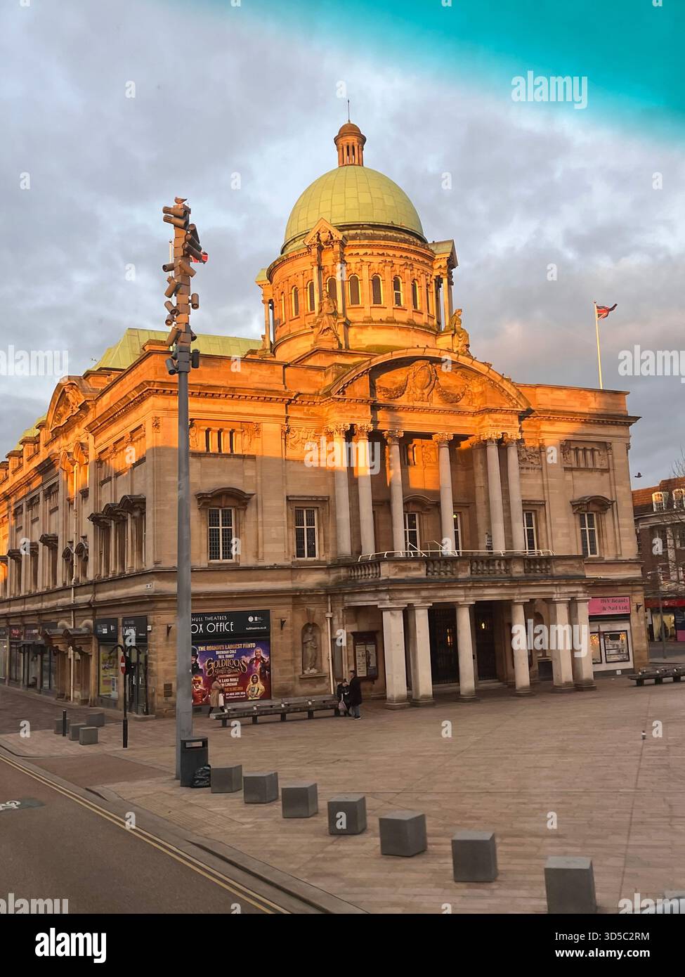 Beautiful view of a historic domed building illuminated by warm sunrise light in Hull, England. Classical architecture and empty city streets create - Smartphone Captured Stock Image