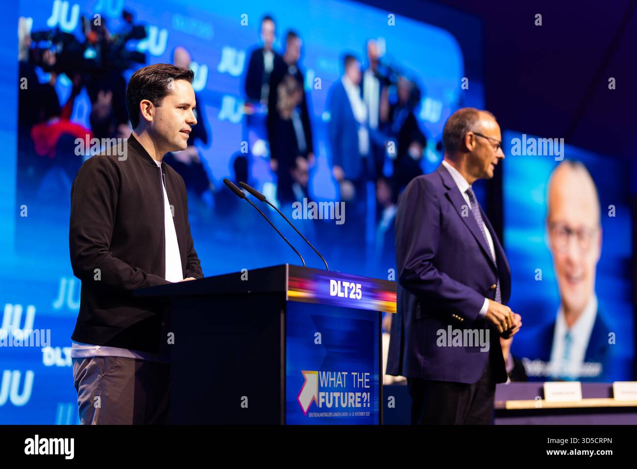 Rust, Germany. 15th Nov, 2025. Johannes Winkel (l, CDU), Federal Chairman of the Junge Union (JU), stands on stage next to Federal Chancellor Friedrich Merz (CDU) at the Junge Union's Germany Day. The main topic of the three-day congress is likely to be the reform of the social systems. Credit: Philipp von Ditfurth/dpa/Alamy Live News Stock Photo
