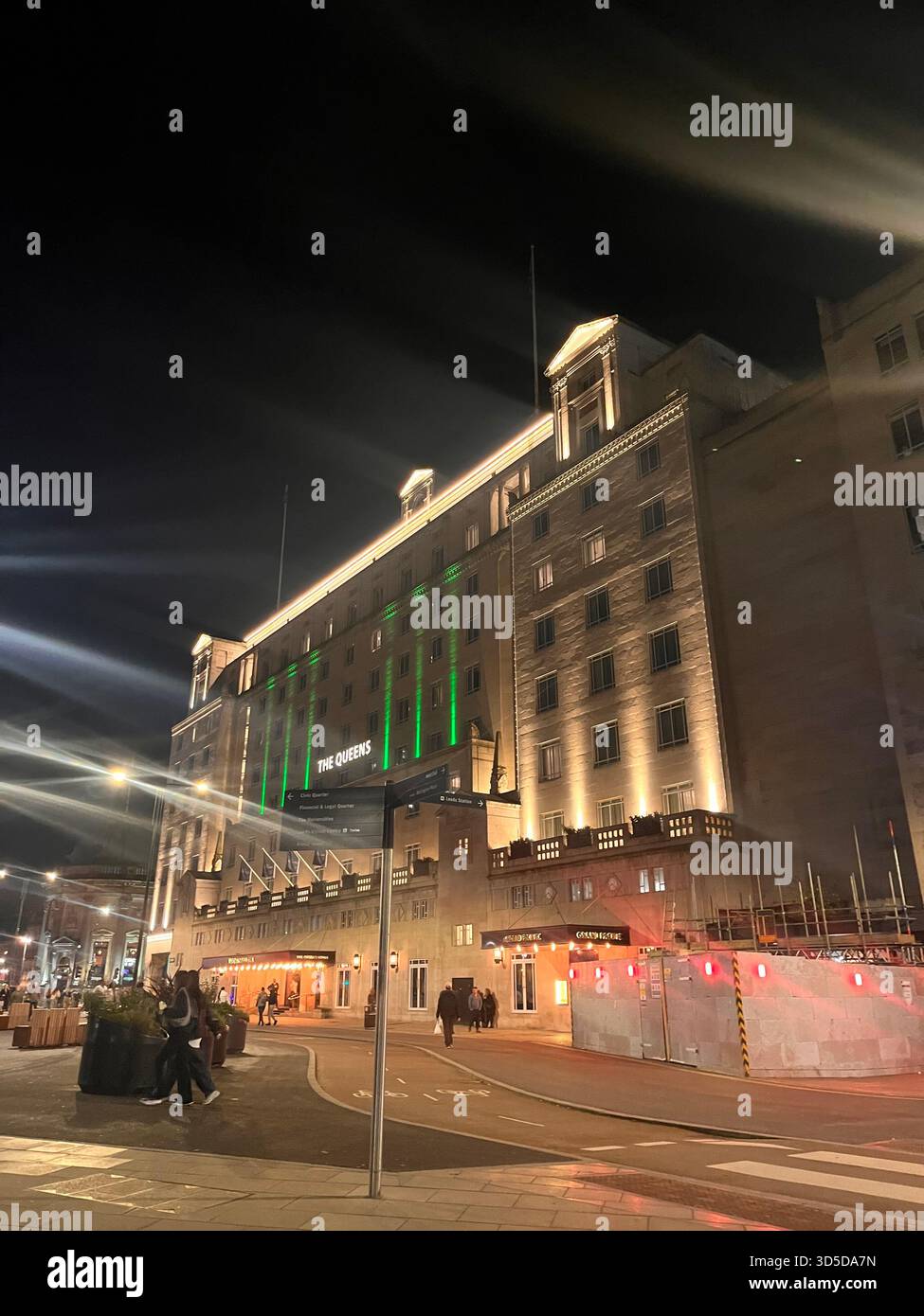 Luxury hotel and commercial building with green accent lighting in Leeds city centre, England, captured at night. - Smartphone Captured Stock Image