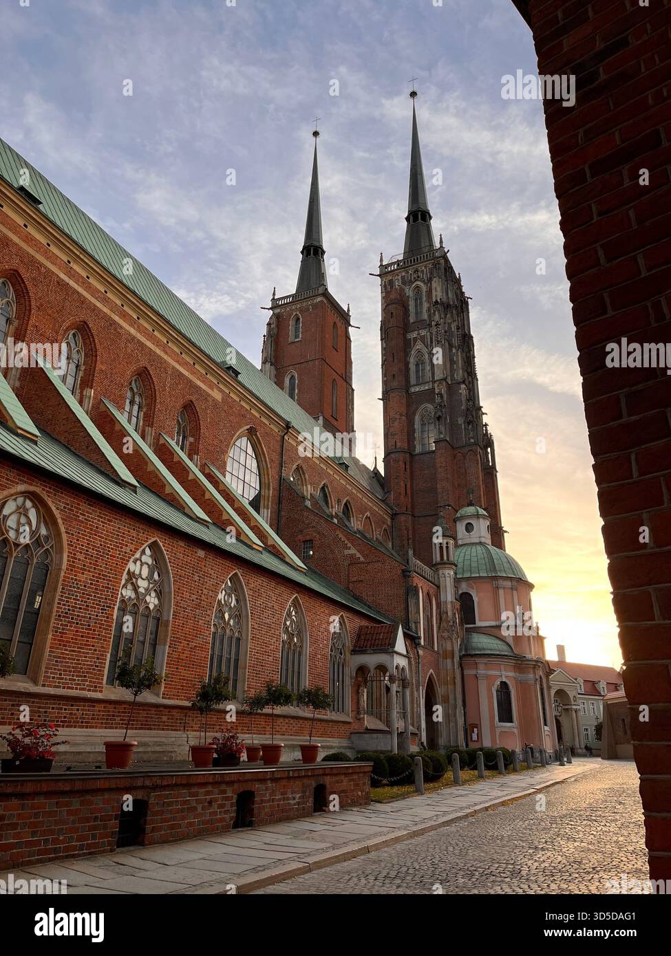 A quiet cobblestone street lined with traditional brick buildings in the historic center of Wrocław, Poland. - Smartphone Captured Stock Image