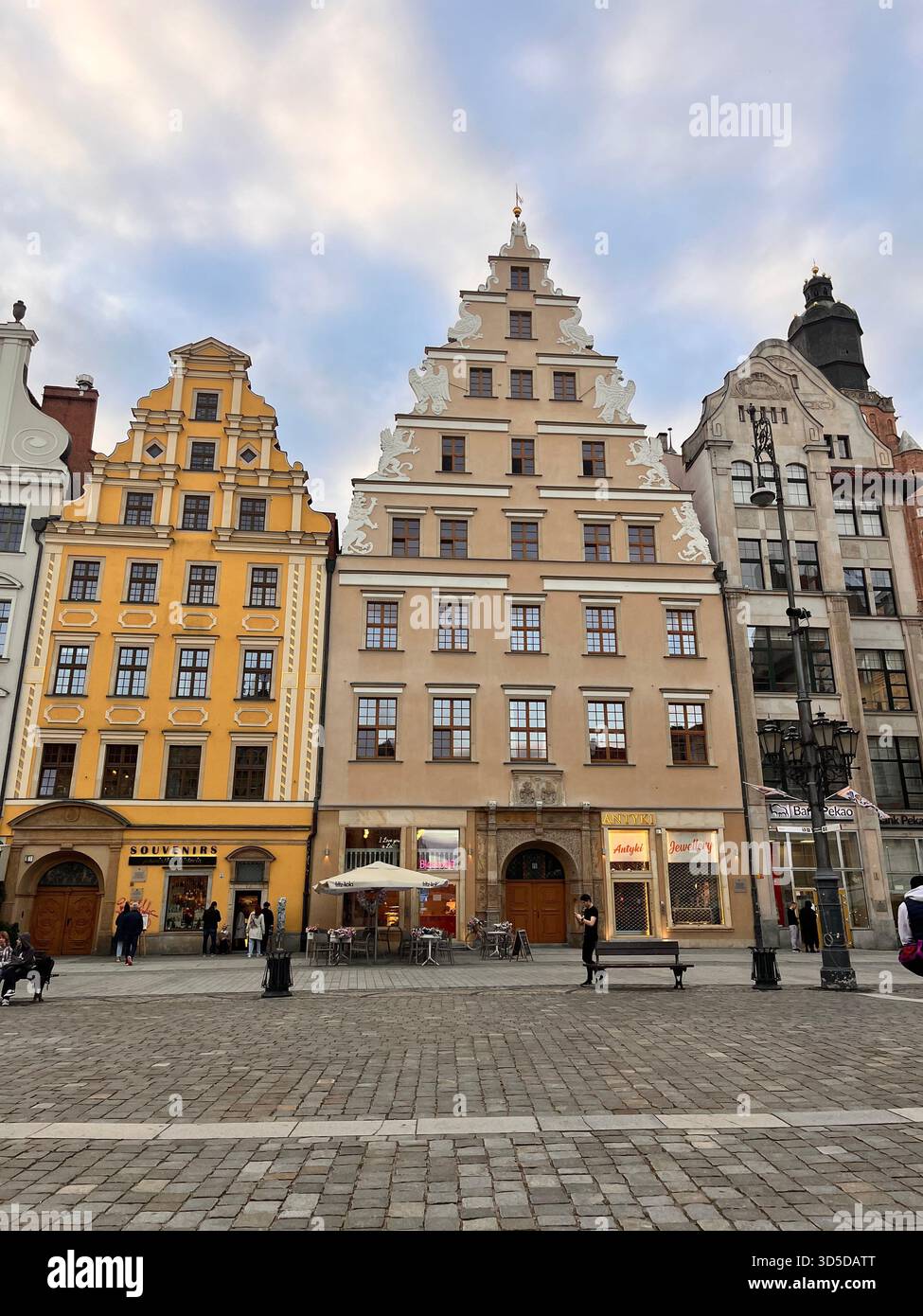 Brightly colored Renaissance-inspired townhouses lining the historic Market Square in Wrocław, Poland. The architectural symmetry and pastel tones - Smartphone Captured Stock Image