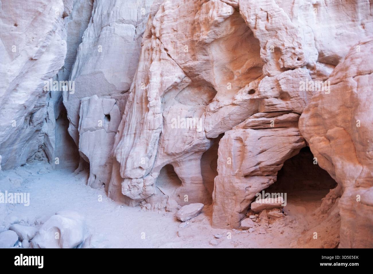 A rocky cave with a small hole in the wall. The cave is empty and the ...