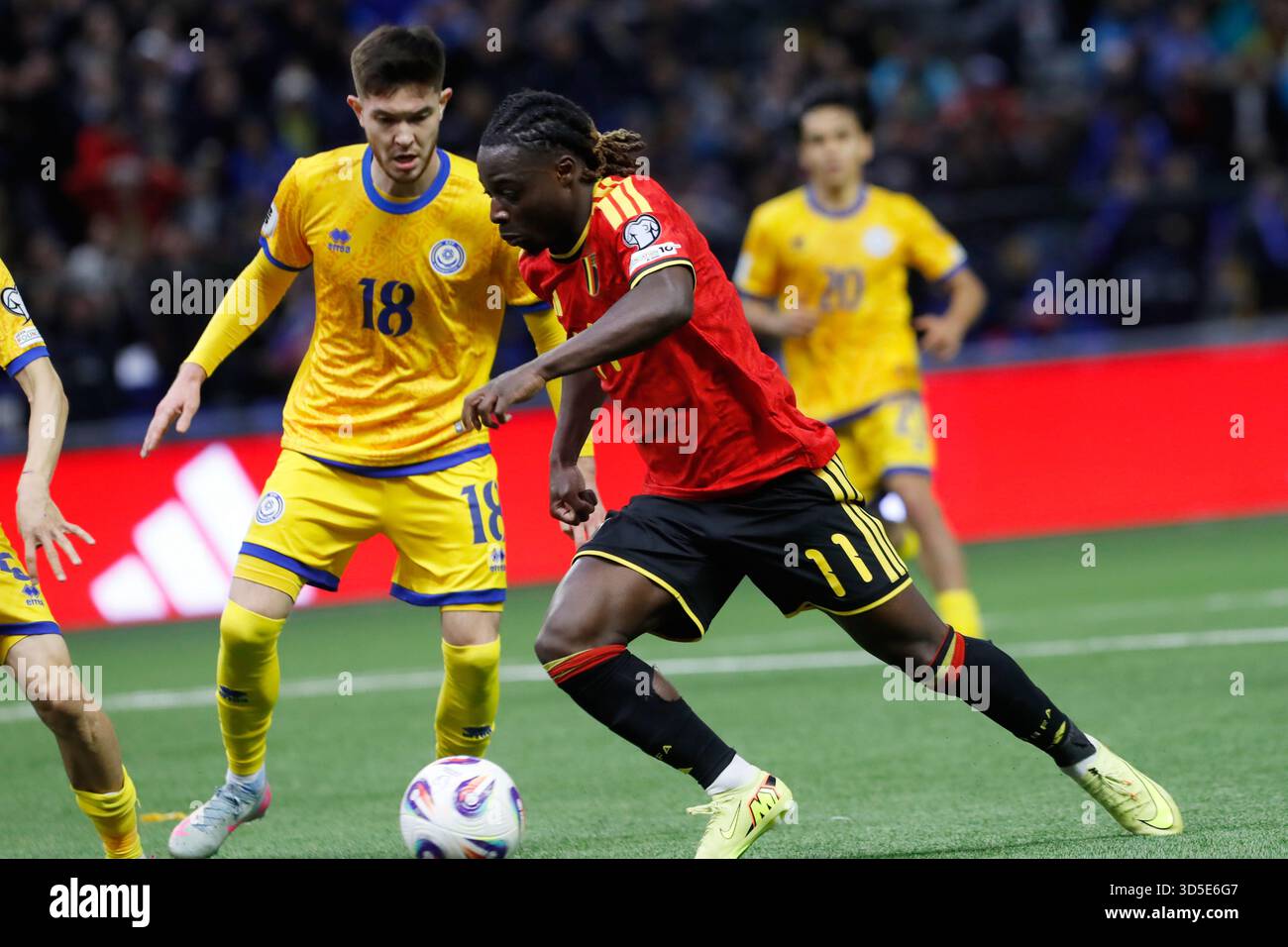 Kazakhstan's Dinmukhamed Karaman, left, and Belgium Jeremy Doku ...