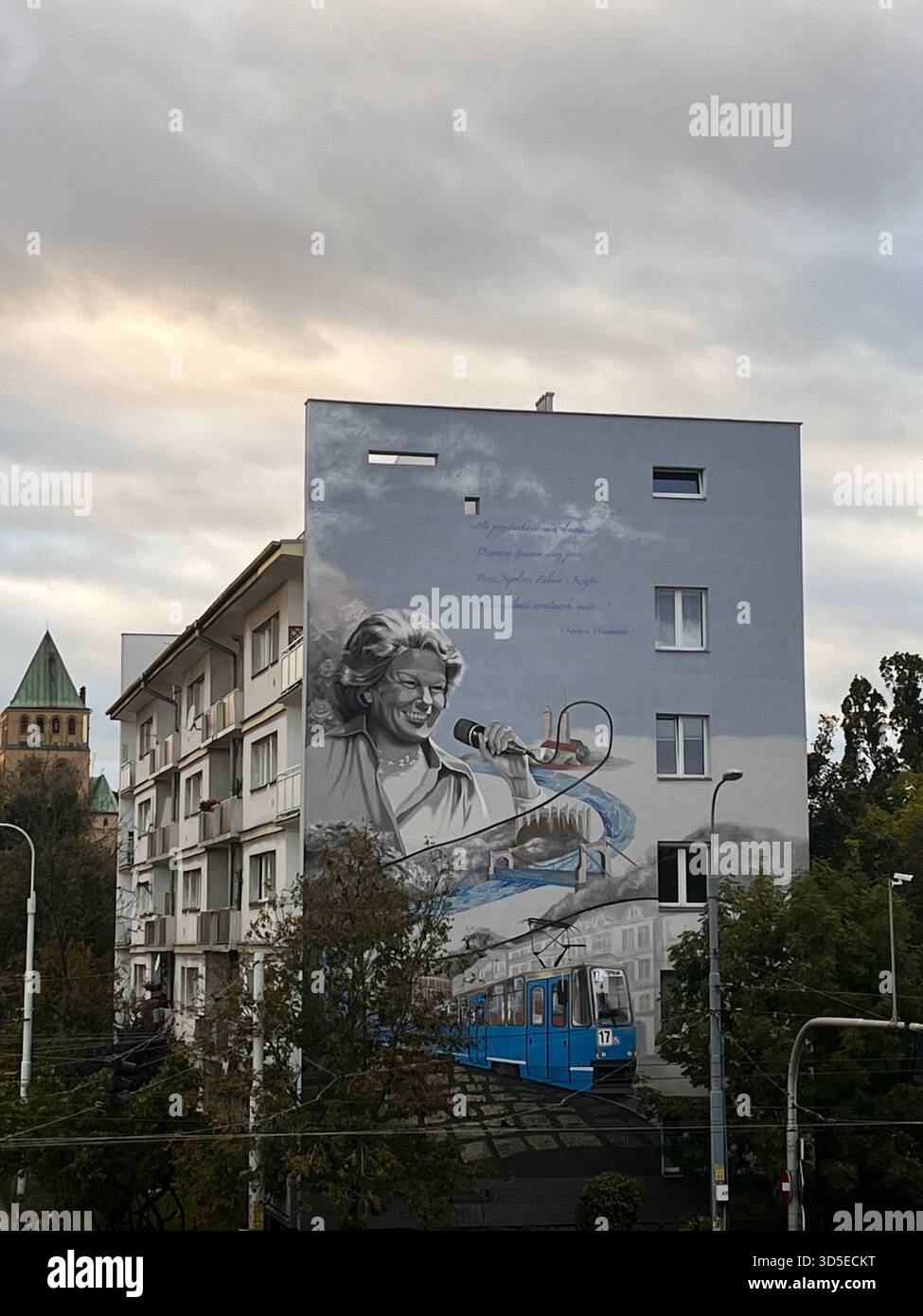 A striking mural featuring an artistic portrait painted on the side of a residential building in Wrocław, Poland. - Smartphone Captured Stock Image