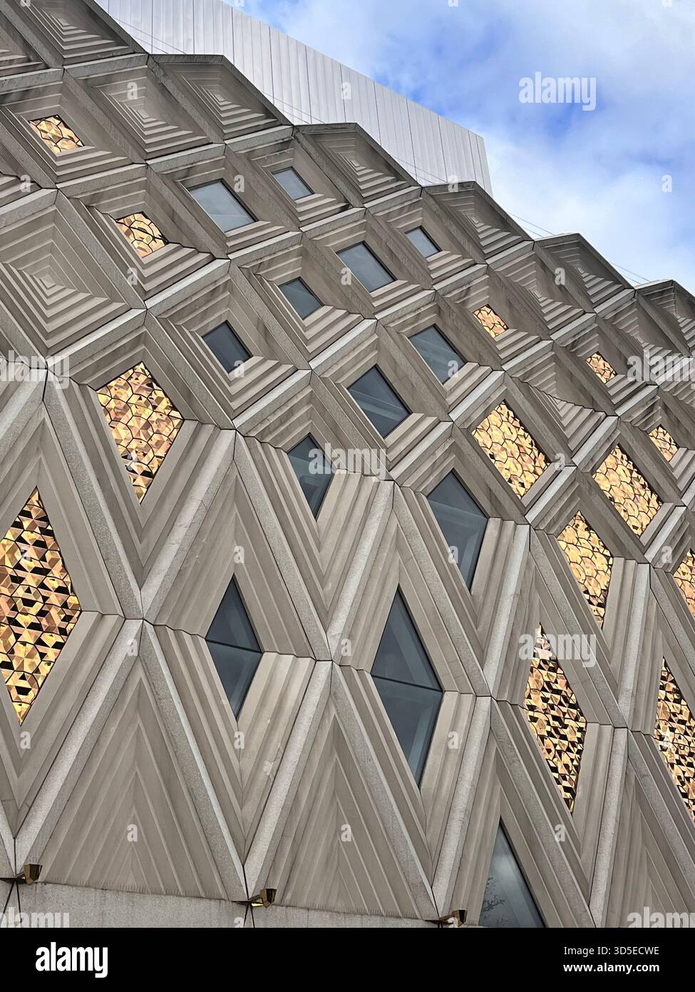 A contemporary Leeds building featuring a unique geometric facade with hexagonal windows and wooden accents. - Smartphone Captured Stock Image