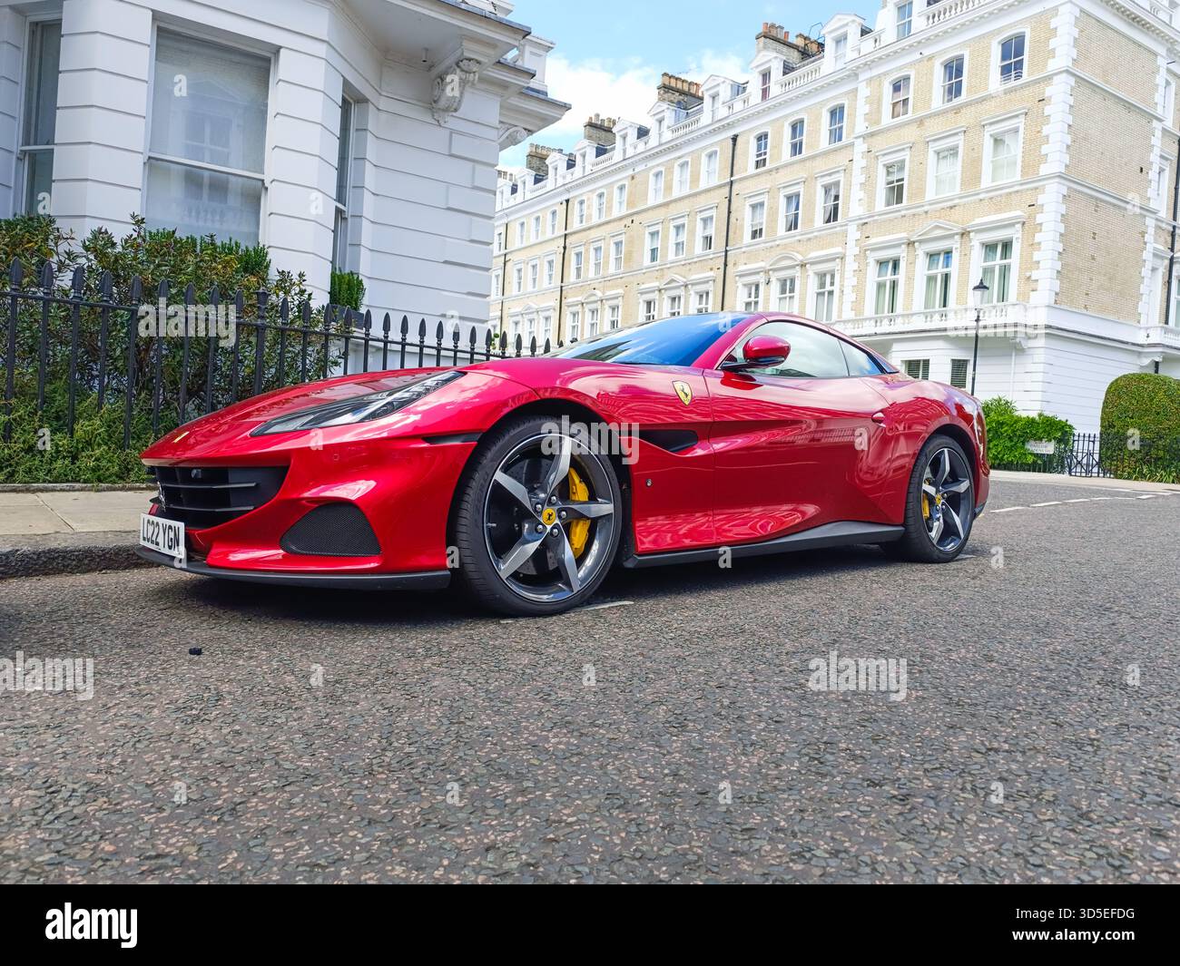 Red Ferrari Portofino convertible on upscale city street. London, UK, 17 June 2024 Stock Photo
