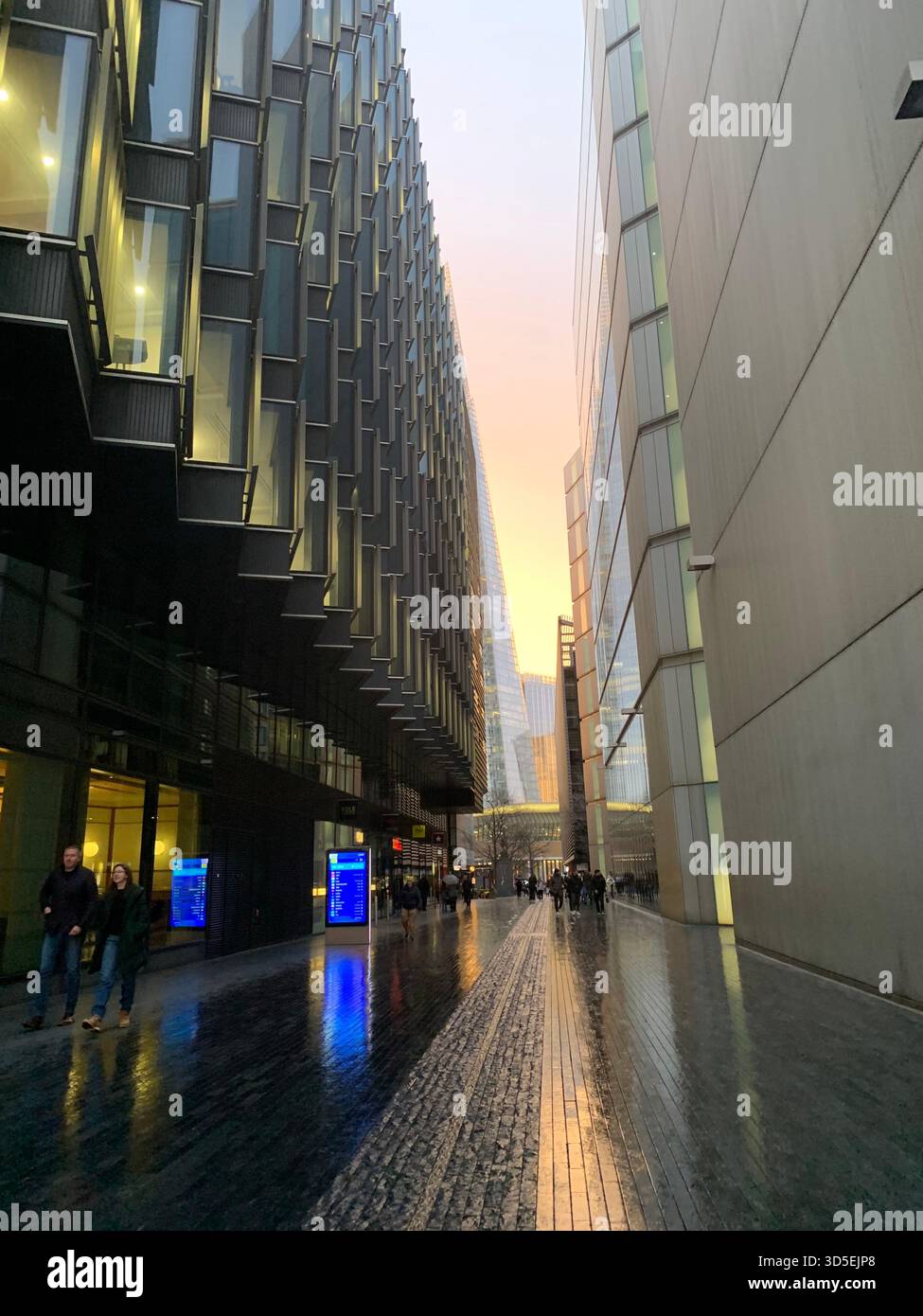 Sunset view of The Shard rising between modern glass buildings in central London. - Smartphone Captured Stock Image