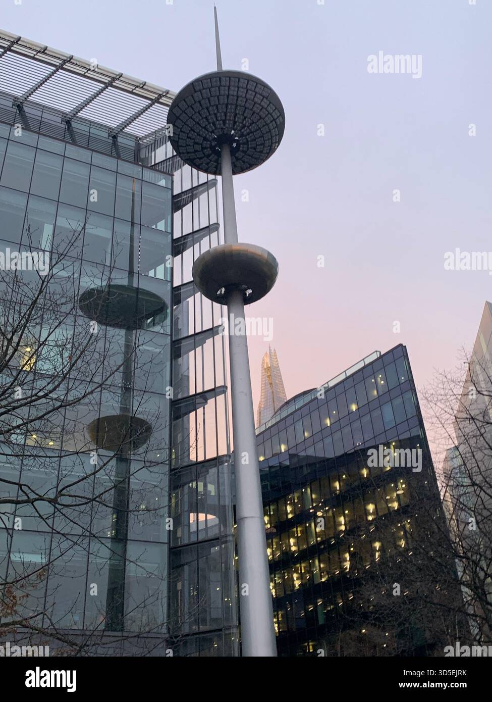 Low-angle view of modern office buildings and street lighting in the City of London financial district. - Smartphone Captured Stock Image