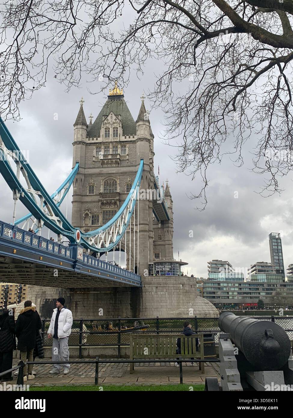 View of Tower Bridge from the Thames riverside on a cloudy day. Historic landmark and architectural symbol of London, England. - Smartphone Captured Stock Image