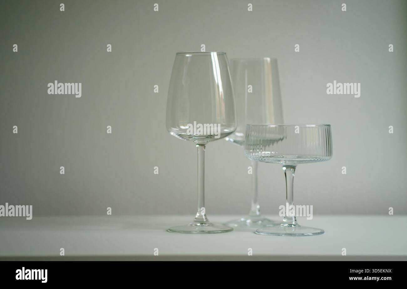 Three different glass goblets on the table. Glassware for alcoholic drinks. Barware. Stock Photo
