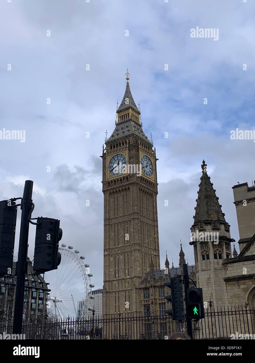 Iconic view of Big Ben and the Palace of Westminster in central London, England. Historic Gothic Revival architecture captured on a cloudy day - Smartphone Captured Stock Image