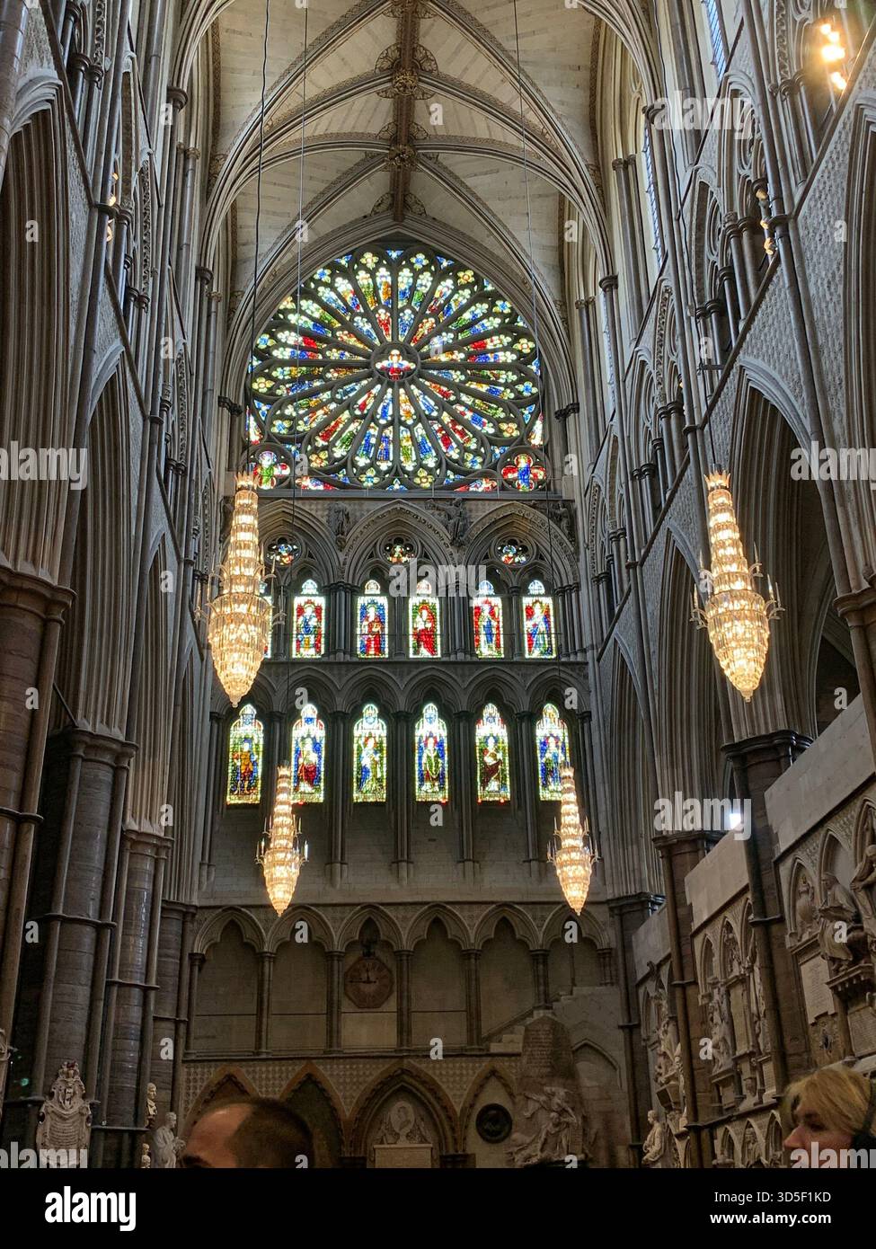 Interior view of the magnificent rose window inside Westminster Abbey in London, England. Colorful stained glass illuminated by natural light - Smartphone Captured Stock Image