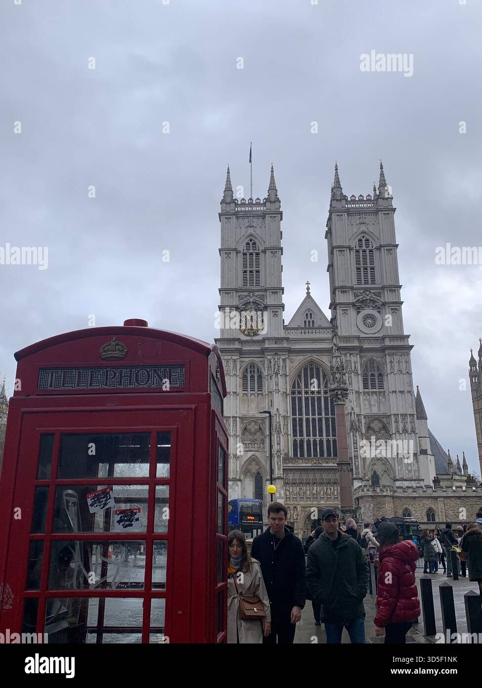 View of Westminster Abbey with a classic red British telephone box in the foreground, London, England. - Smartphone Captured Stock Image