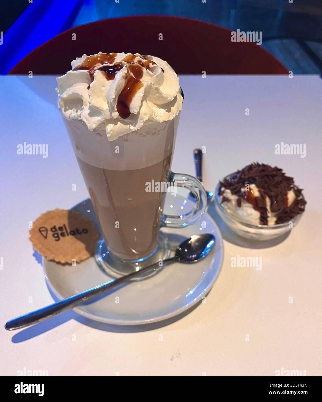 Close-up of a hot chocolate topped with whipped cream served in a café in Hull, England. A cozy lifestyle image representing British café culture - Smartphone Captured Stock Image