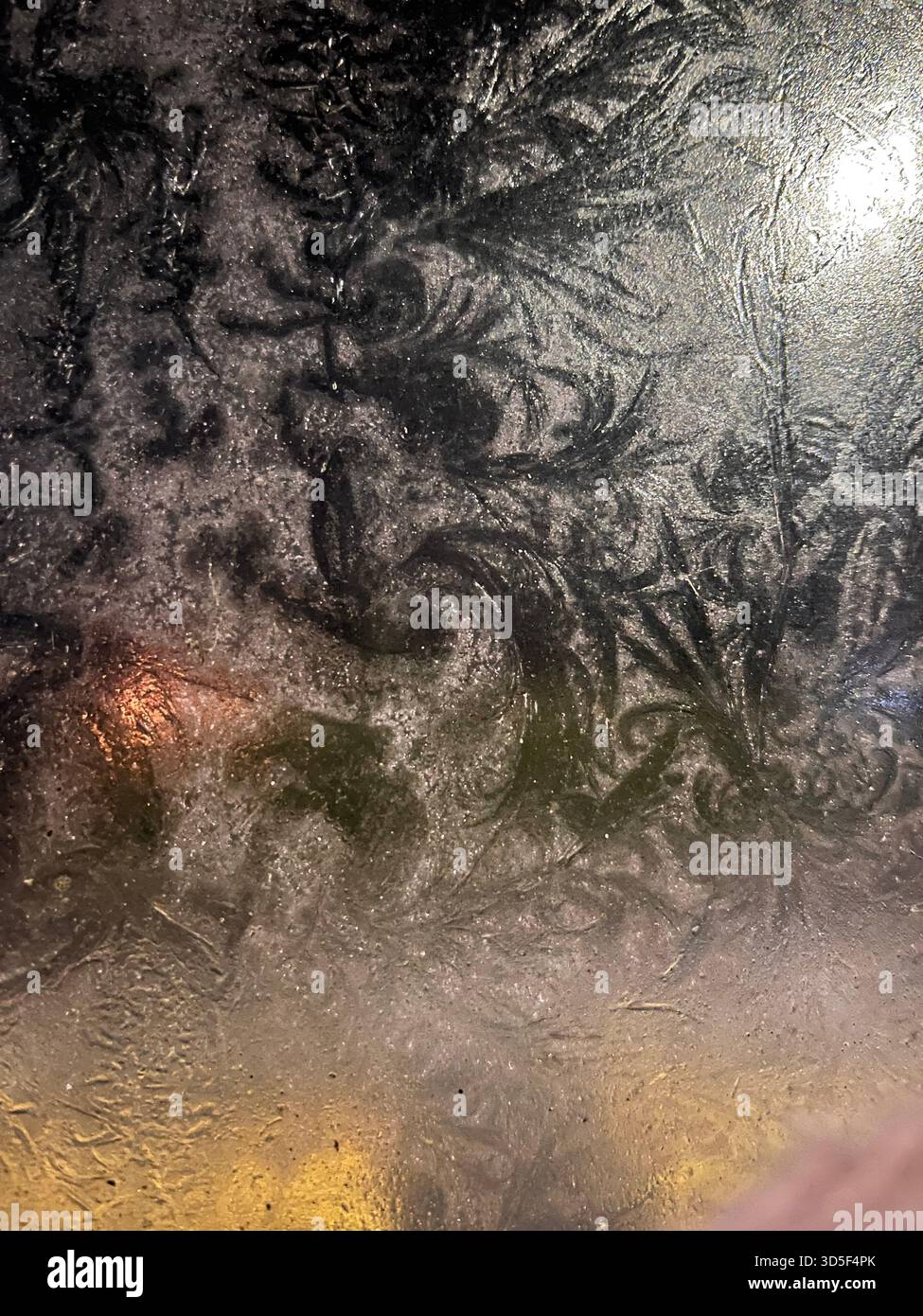 Abstract frost formations on a glass surface in Hull, England, creating natural icy patterns and textures during cold winter weather. - Smartphone Captured Stock Image