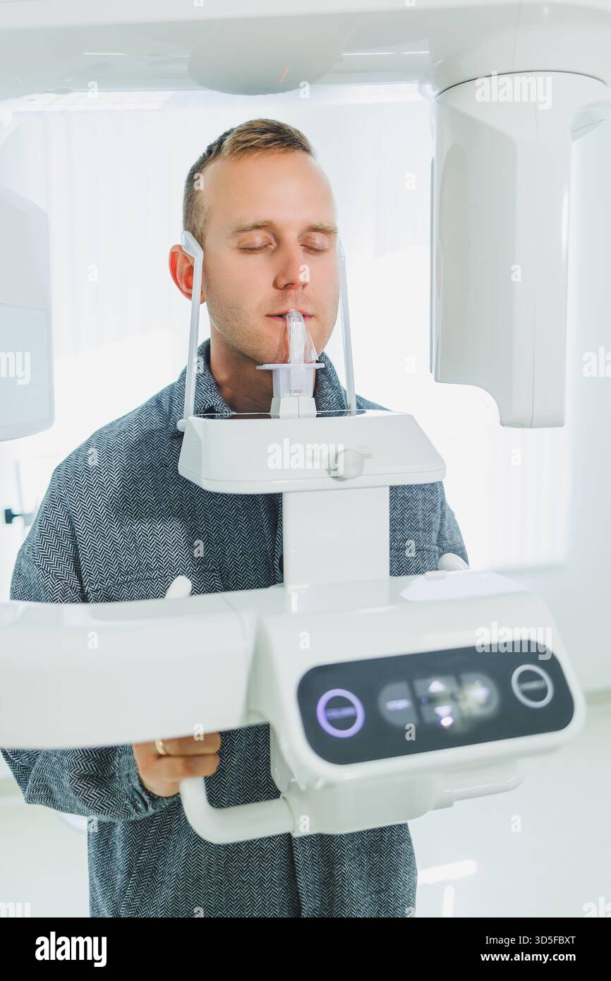 A young man underwent a CT scan of the jaw, a circular image of the jaw in modern dentistry. Radiology, panoramic scanner. Stock Photo